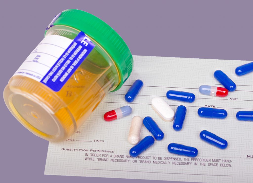 A urine sample next to an assortment of pills